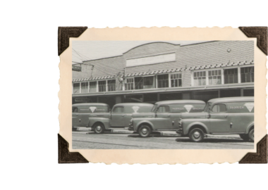 The exterior of Parrish Bakeries with a line of delivery trucks sitting outside.