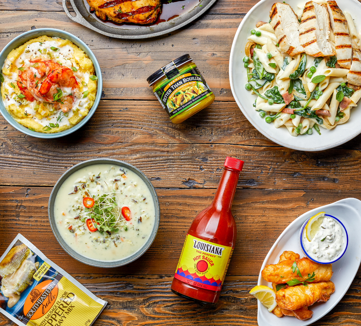 Top down view of a table with various Summit Hill Foods products and prepared recipes using those products.
